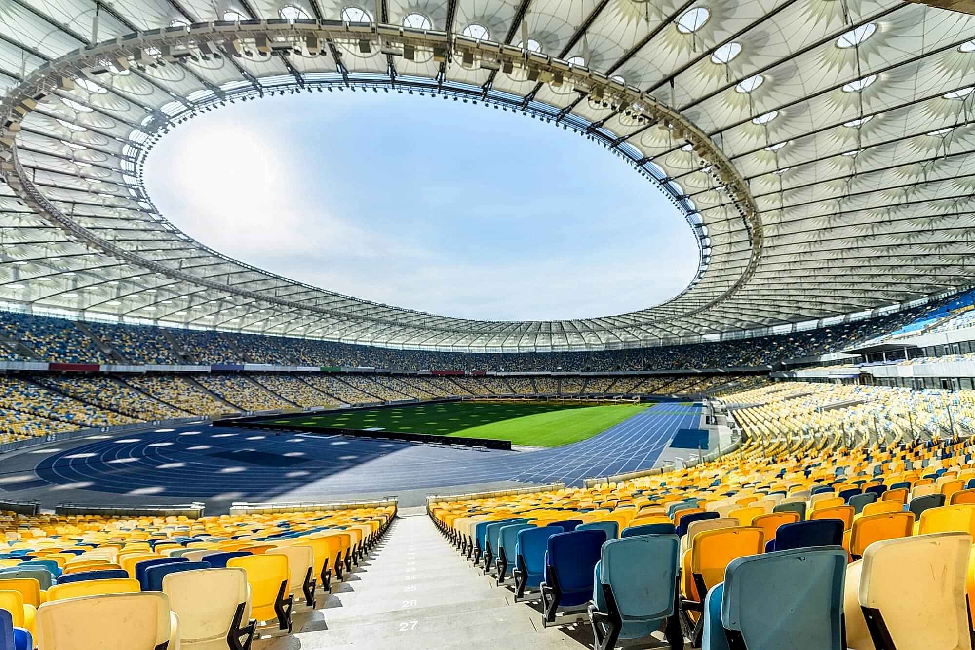 rows-of-yellow-and-blue-stadium-seats-on-soccer-field-stadium.jpg